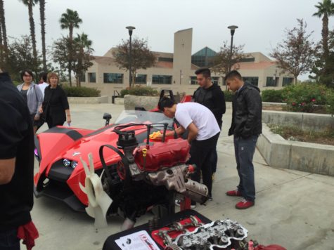 Automotive engineering students show off their red (and rather slow) car