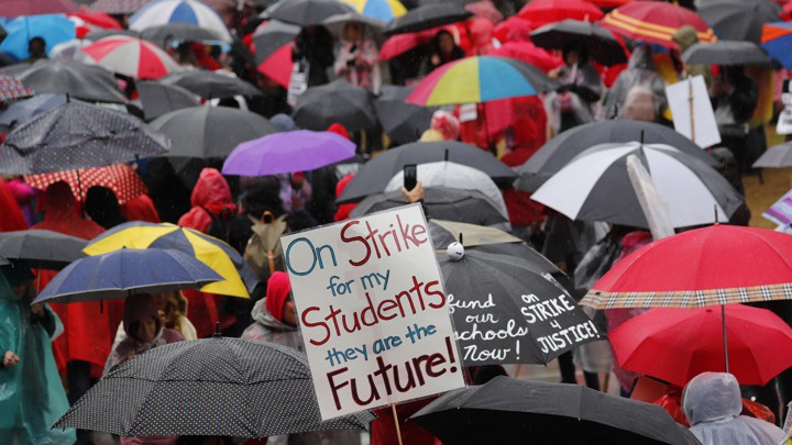 Some of the more than 30,000 teachers in the Los Angeles public school system hold a rally at City Hall after going on strike in Los Angeles, California, U.S., January 14, 2019. REUTERS/Mike Blake - HP1EF1E1H59XE