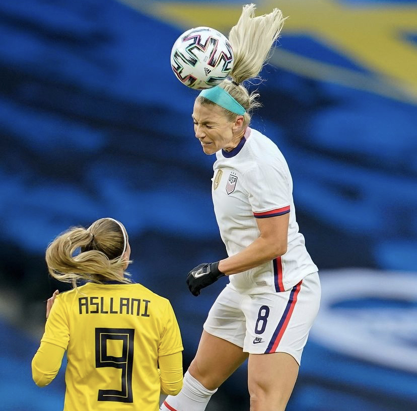 Julie Ertz heading the ball to win it in the air. 