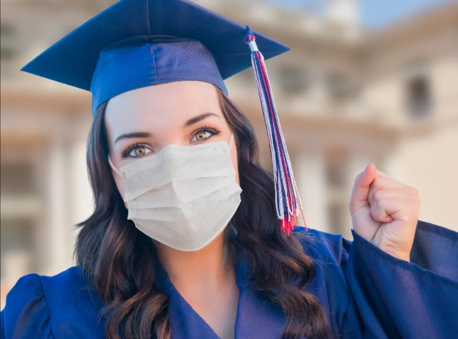 High school senior is wearing a mask, along with her cap and gown.