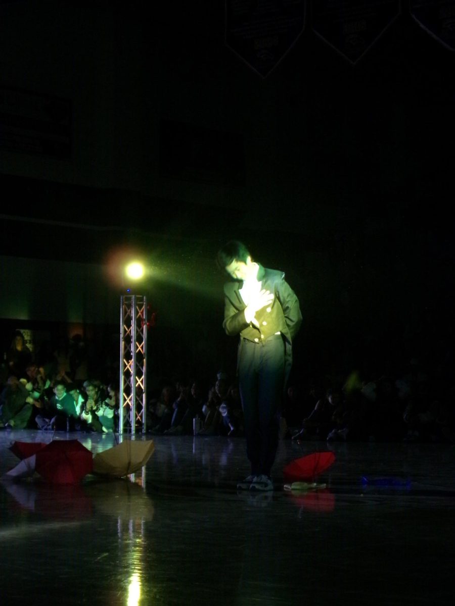 Mick Chen bows after his magic performance at the pep rally