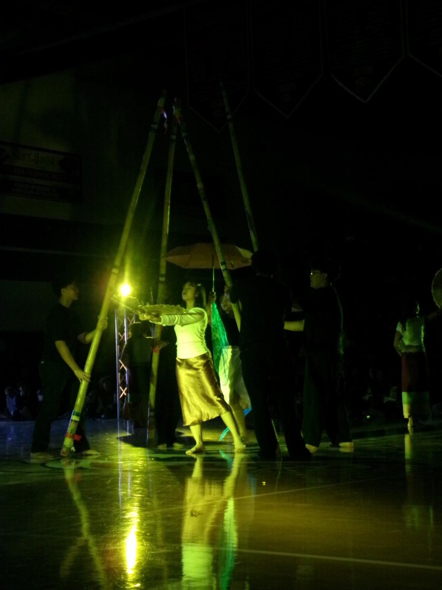 AFA performing as a light shines behind them