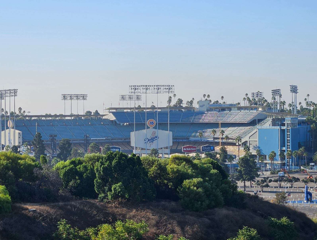 A scenic photo of Dodger Stadium, taken from atop some nearby hills.