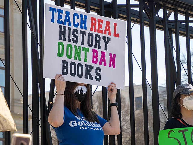 A lady protesting about her opinions on the book ban.