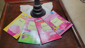 A collection of Pinkalicious books with sticky notes that say "Banned?" on them.