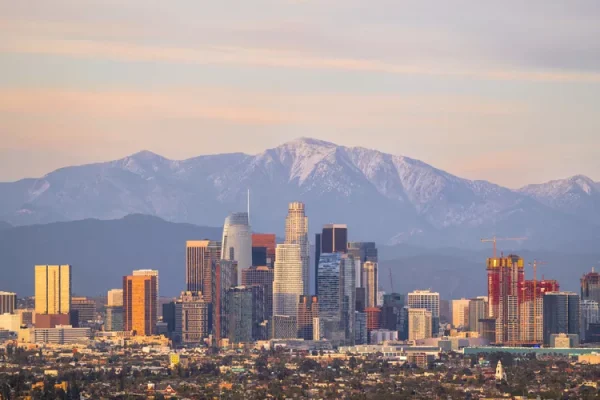 A view of the Los Angeles skyline with mountains in the background. 