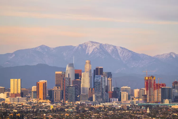 A view of the Los Angeles skyline with mountains in the background. 