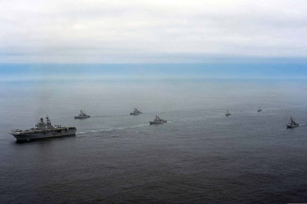 Future amphibious assault ship USS America (LHA 6), left, and ships from the Peruvian navy sail in formation during a passing exercise (PASSEX) in the Pacific Ocean. America is currently traveling through the U.S. Southern Command and U.S. 4th Fleet area of responsibility on its maiden transit, "America Visits the Americas." America is the first ship of its class, replacing the Tarawa-class of amphibious assault ships. As the next generation "big-deck" amphibious assault ship, America is optimized for aviation, capable of supporting current and future aircraft such as the MV-22 Osprey and F-35B Joint Strike Fighter. The ship is scheduled to be ceremoniously commissioned Oct. 11 in San Francisco. (U.S. Navy photo by Mass Communication Specialist 2nd Class Ryan Riley/Released)