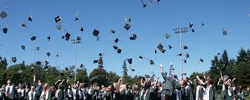 A high school graduation with caps thrown into the air.